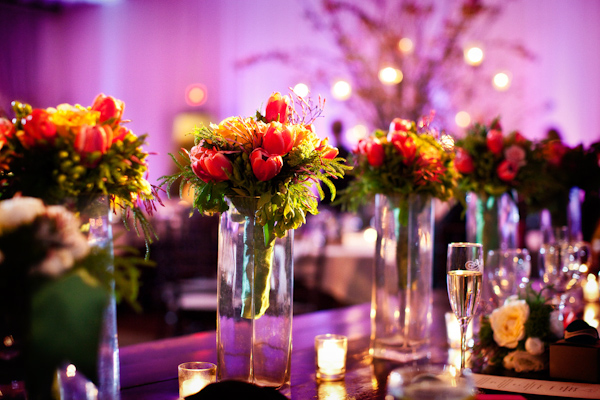 centerpieces on reception seating tables of dark pink tulips with dark green and light green fillers - photo by Washington DC wedding photographers Holland Photo Arts